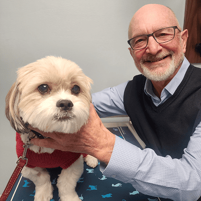 Dr. Dennis Olin, DVM, DACVO, with a small dog